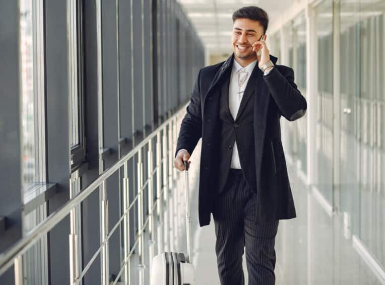 elegant man at the airport with a suitcase