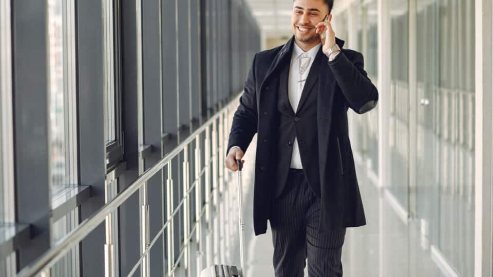 elegant man at the airport with a suitcase